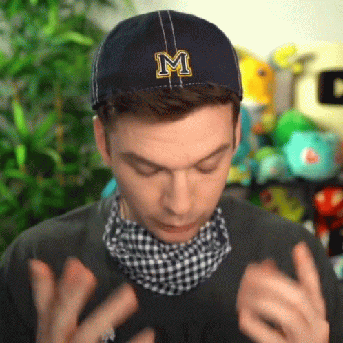 A Man Wearing A Blue Hat With A Letter M On It GIF