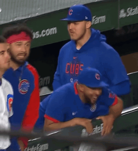 A Man Wearing A Blue Hat With The Letter C On It Stands In A Dugout GIF