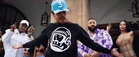 A Man Wearing A Blue Hat With The Number 3 On It Is Dancing With A Group Of People GIF