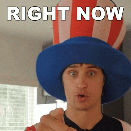 a man wearing a blue hat with the words right now written on it