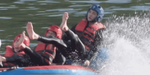 A Man Wearing A Blue Helmet Is Laying On A Raft In The Water GIF