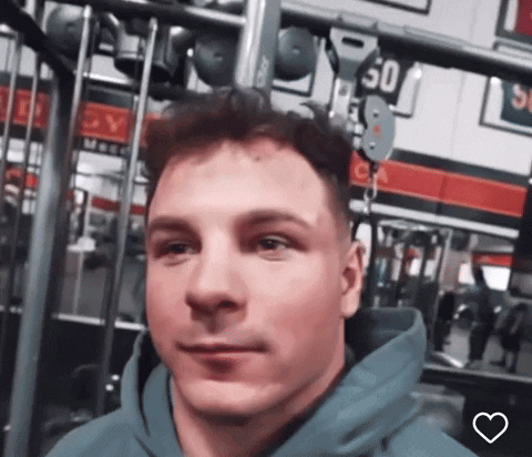 A Man Wearing A Blue Hoodie Is In A Gym With A Sign That Says 50 On It GIF