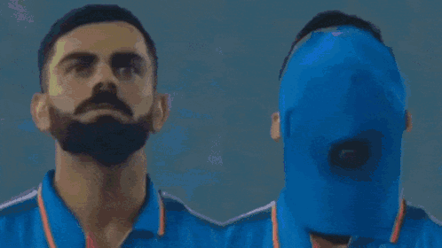 A Man Wearing A Blue India Shirt Looks Up At The Sky GIF