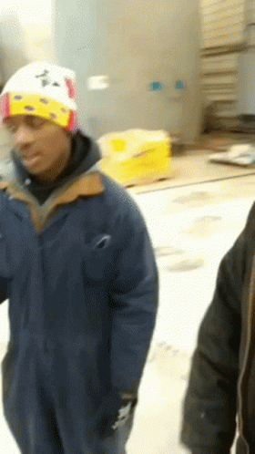 A Man Wearing A Blue Jacket And A White Hat With The Letter A On It GIF