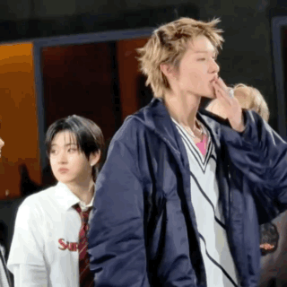 A Man Wearing A Blue Jacket And A White Shirt With The Word Supreme On It GIF