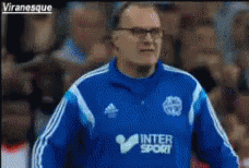 A Man Wearing A Blue Jacket That Says ' Intersport ' On It GIF