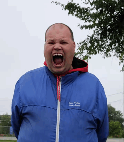 A Man Wearing A Blue Jacket That Says " Super Premium " On The Front GIF