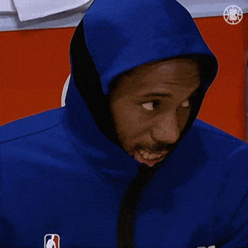 A Man Wearing A Blue Jacket With A Hood On His Head Looks At The Camera GIF