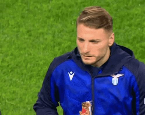 A Man Wearing A Blue Jacket With A White Eagle On It GIF