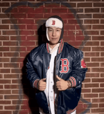 A Man Wearing A Blue Jacket With The Letter B On The Front GIF