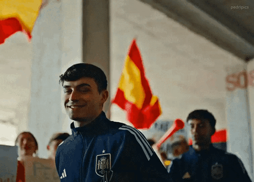 A Man Wearing A Blue Jacket With The Word Adidas On The Front GIF