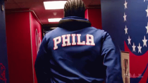 A Man Wearing A Blue Jacket With The Word Phila On The Back GIF