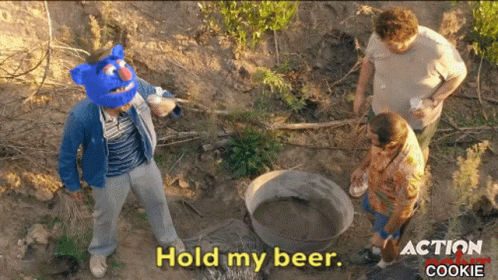 A Man Wearing A Blue Mask Says Hold My Beer GIF