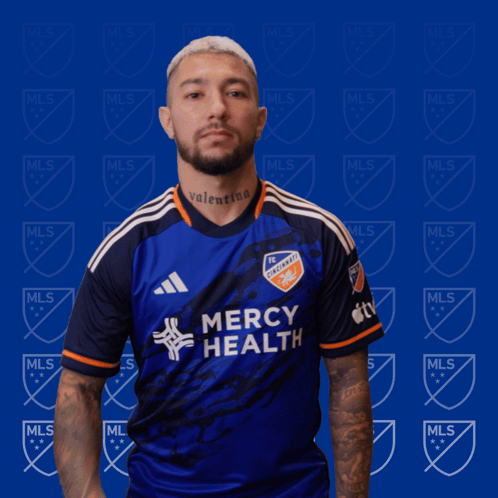 A Man Wearing A Blue Mercy Health Jersey GIF