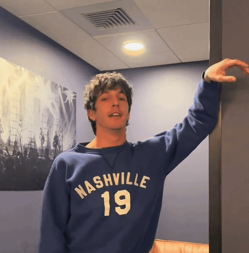 a man wearing a blue nashville 19 sweatshirt