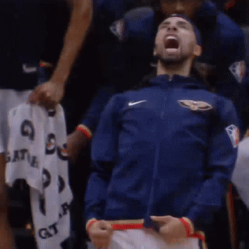 A Man Wearing A Blue Nike Jacket Is Screaming In The Stands GIF