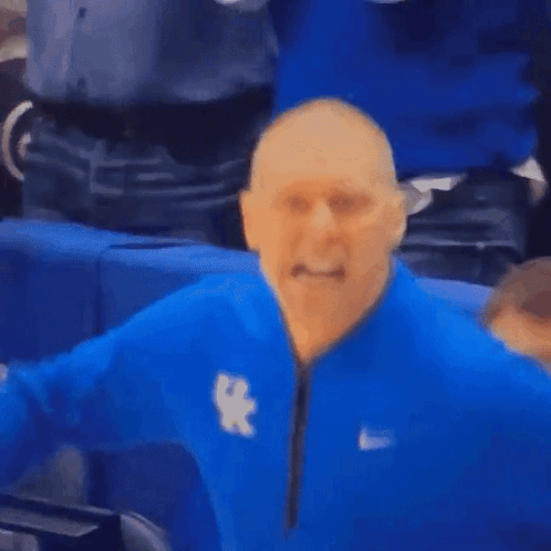 a man wearing a blue nike jacket with the letter x on the front