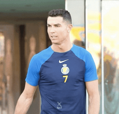 A Man Wearing A Blue Nike Shirt With The Number 7 On The Front GIF