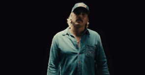 A Man Wearing A Blue Shirt And A Hat That Says Field & Stream GIF