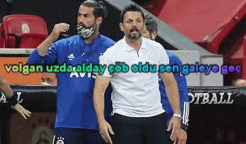 A Man Wearing A Blue Shirt And A White Shirt Is Standing Next To Another Man . GIF