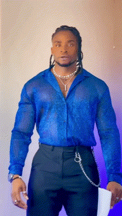 A Man Wearing A Blue Shirt And Black Pants Holds A Piece Of Paper GIF