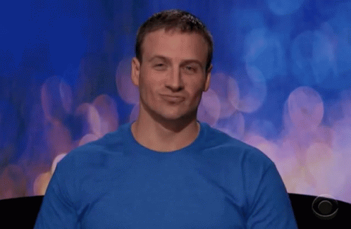 A Man Wearing A Blue Shirt Is Making A Face GIF
