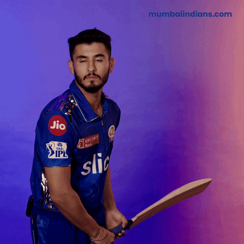 A Man Wearing A Blue Shirt That Says Jio On It Is Holding A Bat GIF