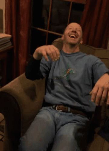 A Man Wearing A Blue Shirt That Says New York Is Laughing GIF