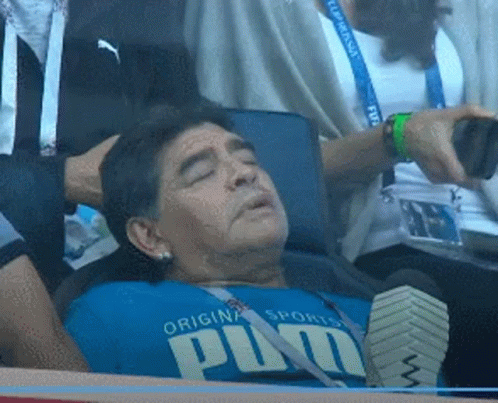 A Man Wearing A Blue Shirt That Says Puma Is Laying Down GIF