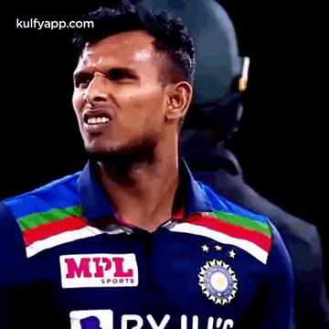 A Man Wearing A Blue Shirt With A Mpl Sports Logo On It . GIF