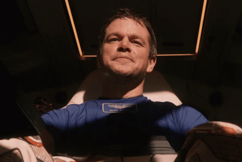 A Man Wearing A Blue Shirt With A Patch That Says " Half Moon " GIF