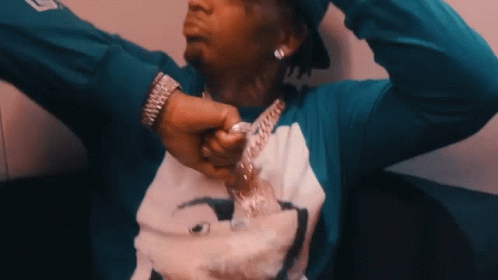 A Man Wearing A Blue Shirt With A Picture On It GIF