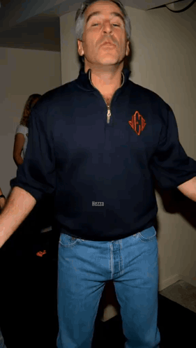 A Man Wearing A Blue Shirt With The Letter G On The Front GIF