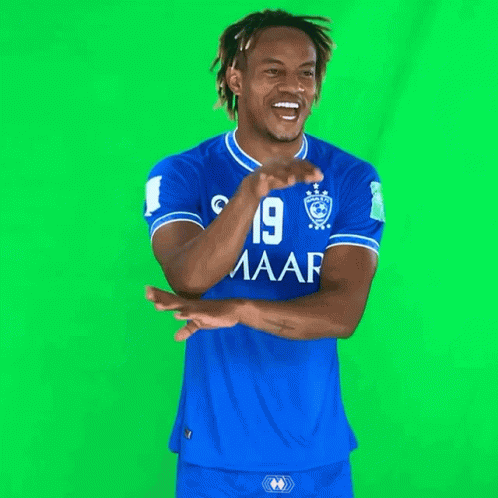 a man wearing a blue shirt with the number 19 on the front