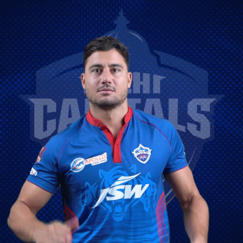A Man Wearing A Blue Shirt With The Word Capitals On The Back GIF