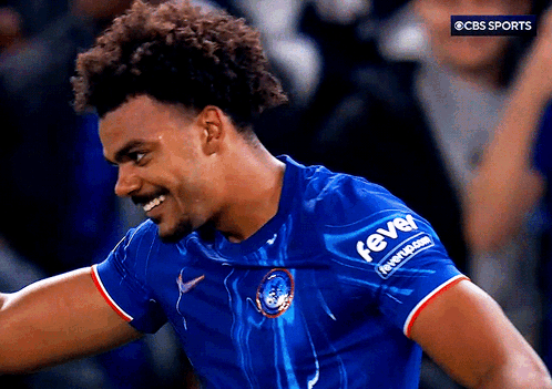 A Man Wearing A Blue Shirt With The Word Fever On The Sleeve GIF