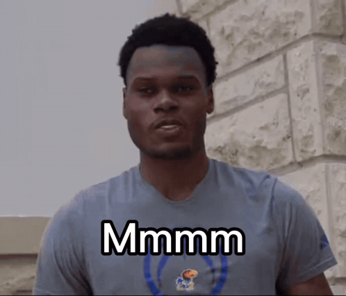 A Man Wearing A Blue Shirt With The Word Mmmm On It GIF