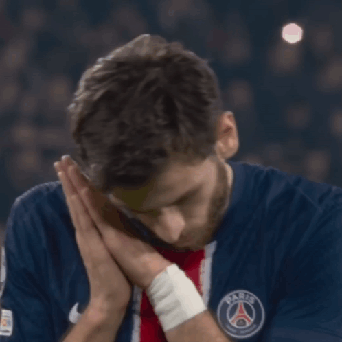 A Man Wearing A Blue Shirt With The Word Paris On The Front GIF