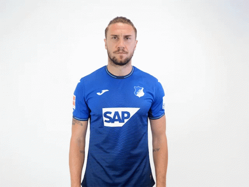 A Man Wearing A Blue Shirt With The Word Sap On The Front GIF