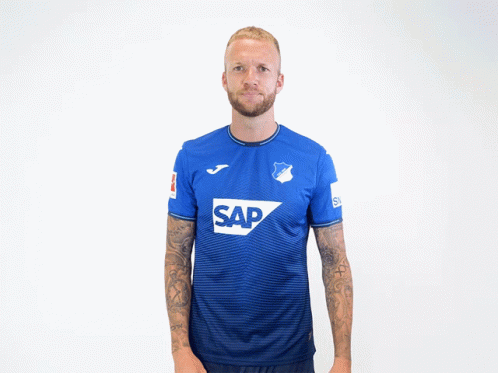 A Man Wearing A Blue Shirt With The Word Sap On The Front GIF