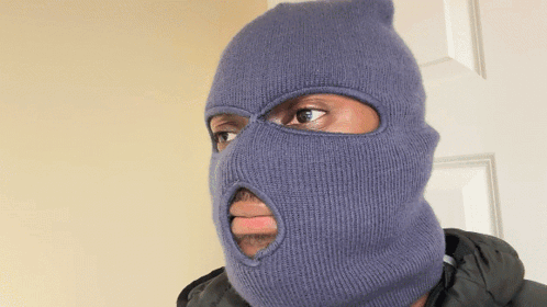 A Man Wearing A Blue Ski Mask With A Hole In The Middle Of His Face GIF