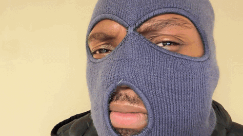 A Man Wearing A Blue Ski Mask With A Hole In The Middle Of His Face GIF