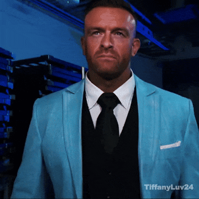 A Man Wearing A Blue Suit And Black Tie With Tiffanyluv24 In The Corner GIF