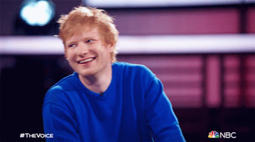 A Man Wearing A Blue Sweater Is Smiling For A Photo That Says #Thevoice On It GIF