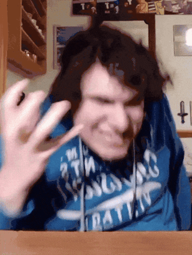 A Man Wearing A Blue Sweatshirt That Says ' Rat ' On It GIF