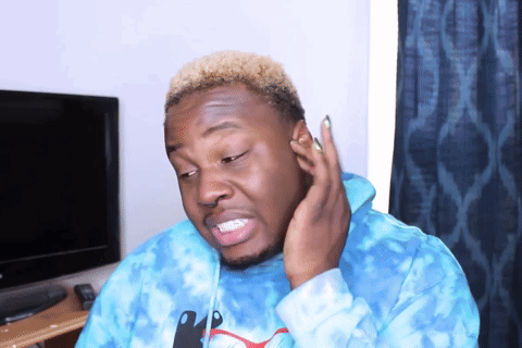 a man wearing a blue tie dye puma sweatshirt is making a funny face