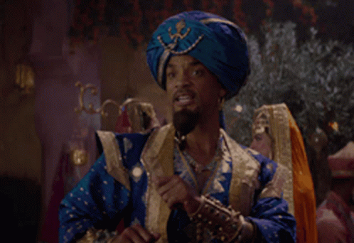 A Man Wearing A Blue Turban Is Talking On A Cell Phone GIF