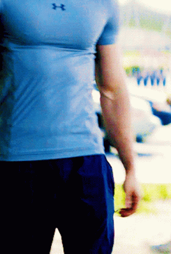 A Man Wearing A Blue Under Armour Shirt And Blue Shorts GIF