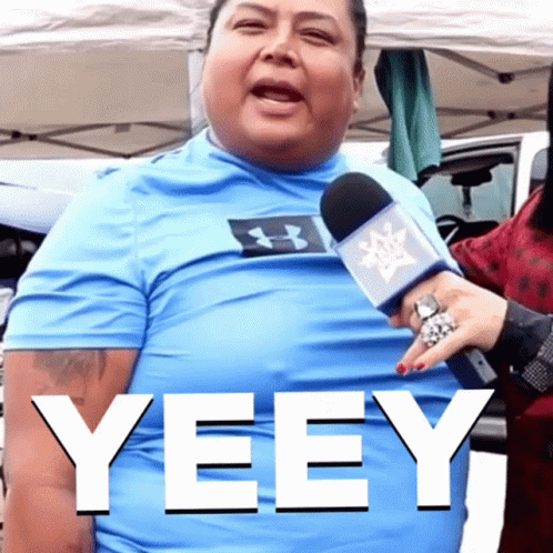 A Man Wearing A Blue Under Armour Shirt Is Being Interviewed By A Woman GIF