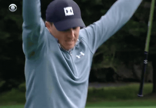 A Man Wearing A Blue Under Armour Shirt Is Holding A Golf Club In His Hands GIF